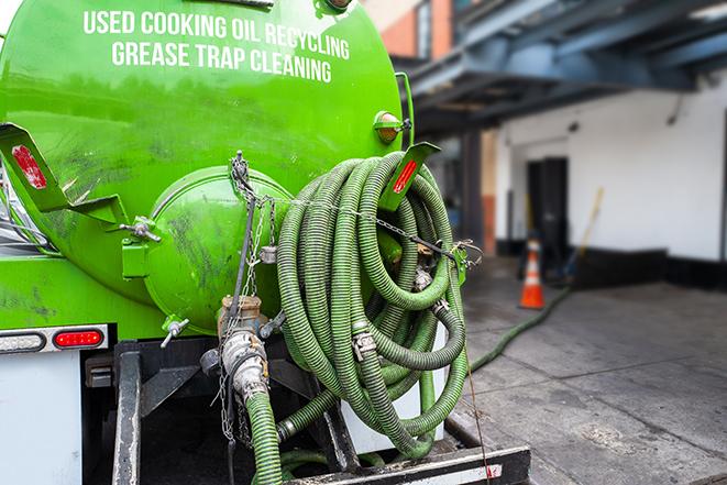 a grease trap being pumped by a sanitation technician in Fairfield, NJ